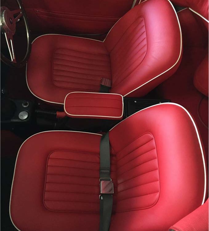 Triumph TR4A fitted with Bright Red Leather Front Seat Covers and Door Panel Casings.