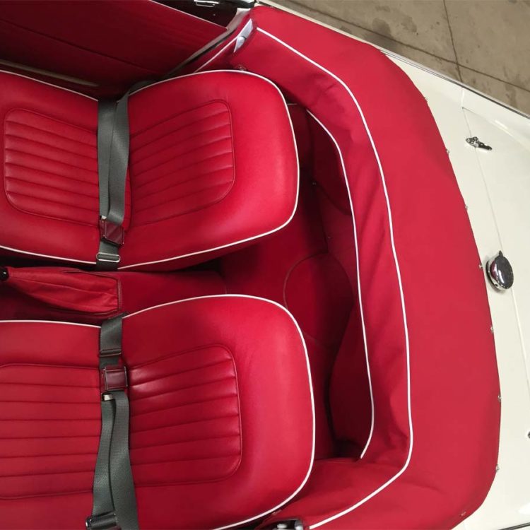 Triumph TR4A fitted with Bright Red Leather Front Seat Covers, Hood Frame Cover, and Bright Red Wool Carpets.