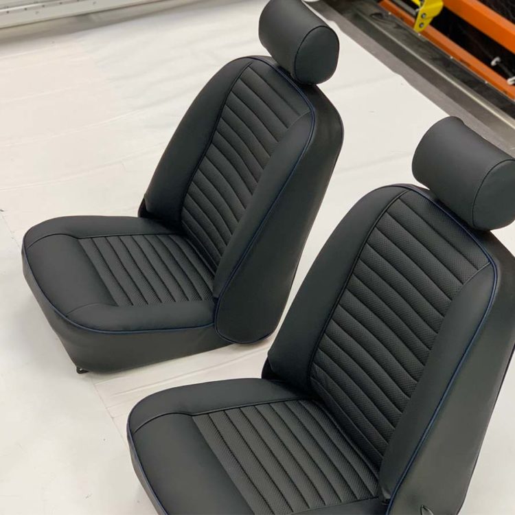 Triumph TR6 Front Seats & Headrests (CF/CR) fully trimmed in Black Leather & Vinyl Covers, with Embossed Pleated Panels.