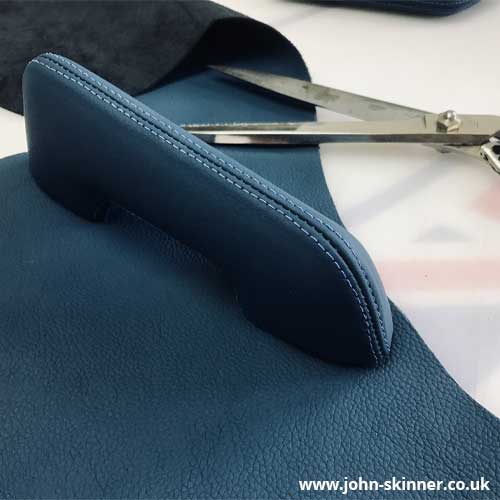 E-Type armrest trimmed in leather with topstitching